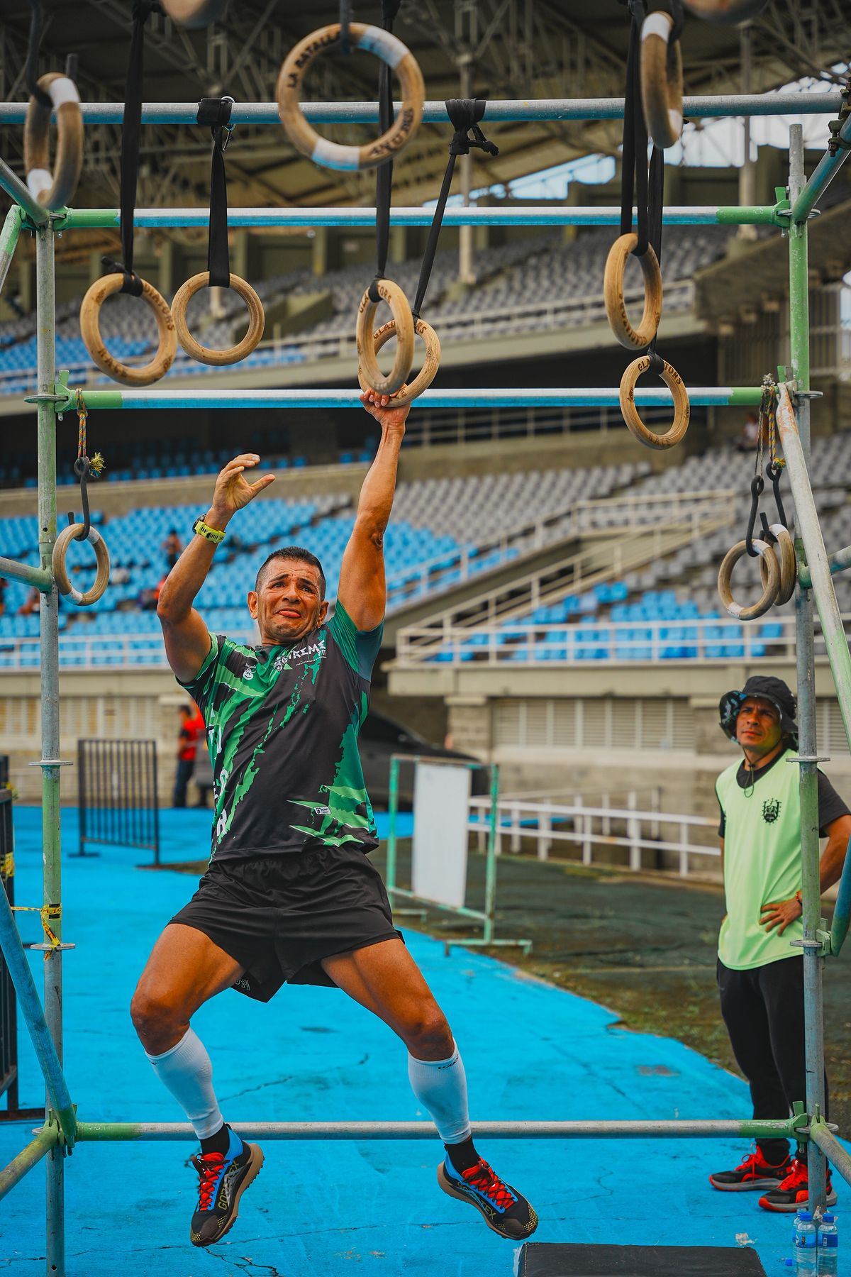 Athlete crossing rings on an obstacle course